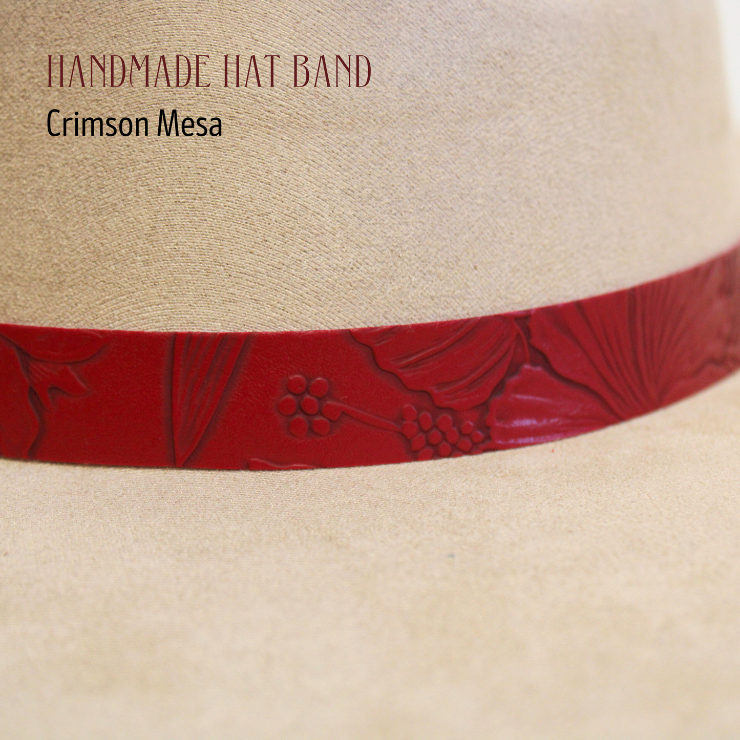 Beige hat with a red band featuring embossed designs on a white background.