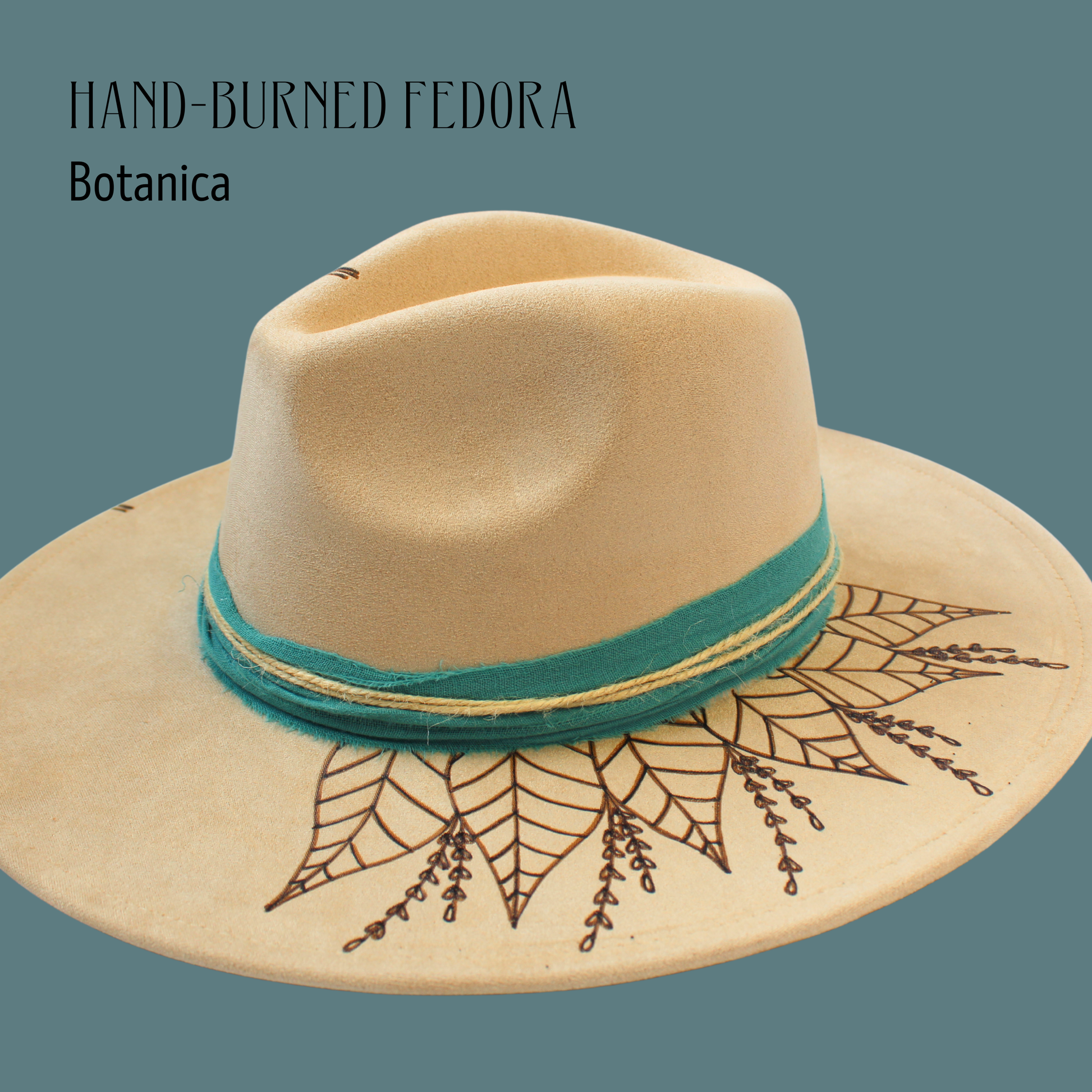 Hand-burned Fedora with botanical design and teal band on a solid background