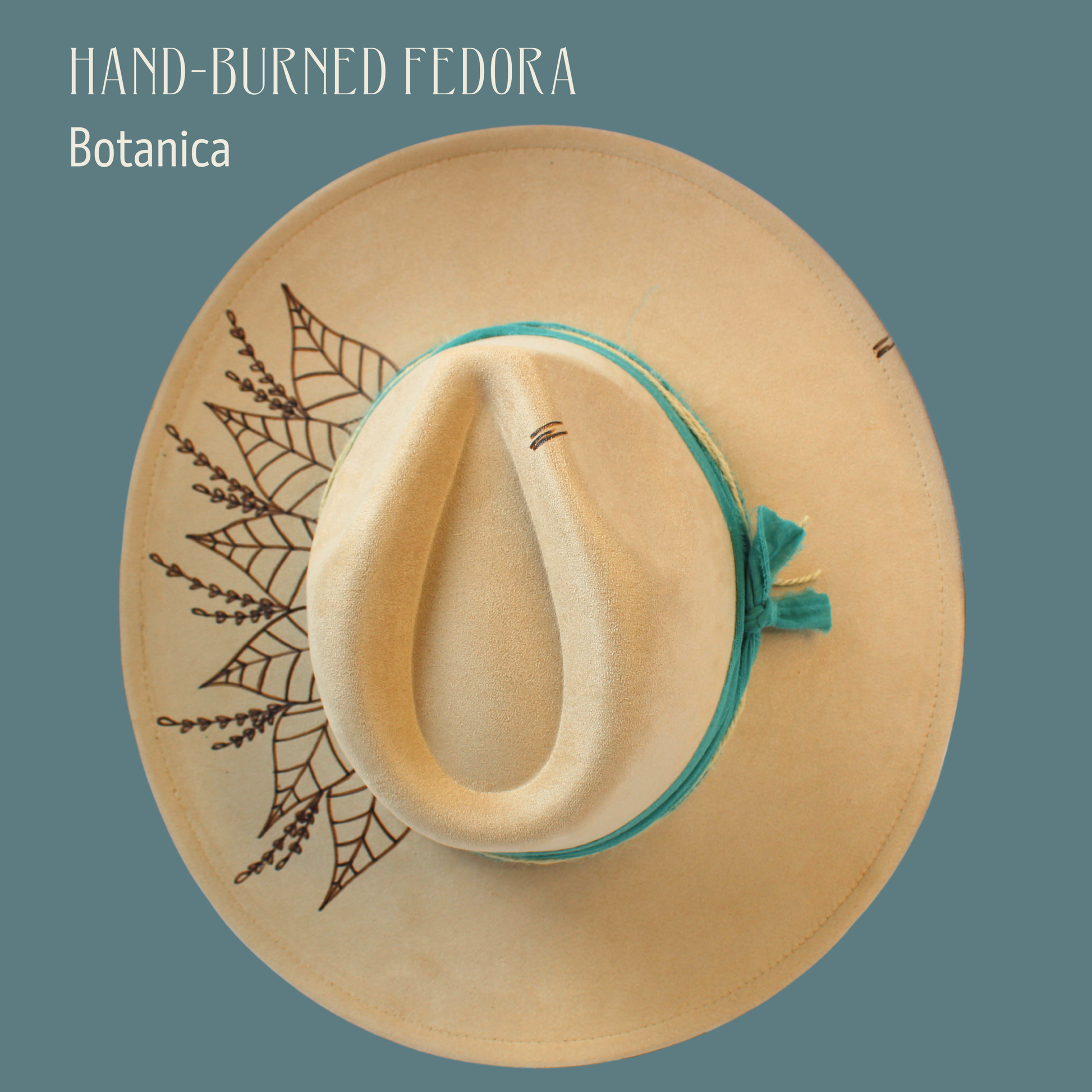 Hand-burned Fedora with botanical design on a teal background