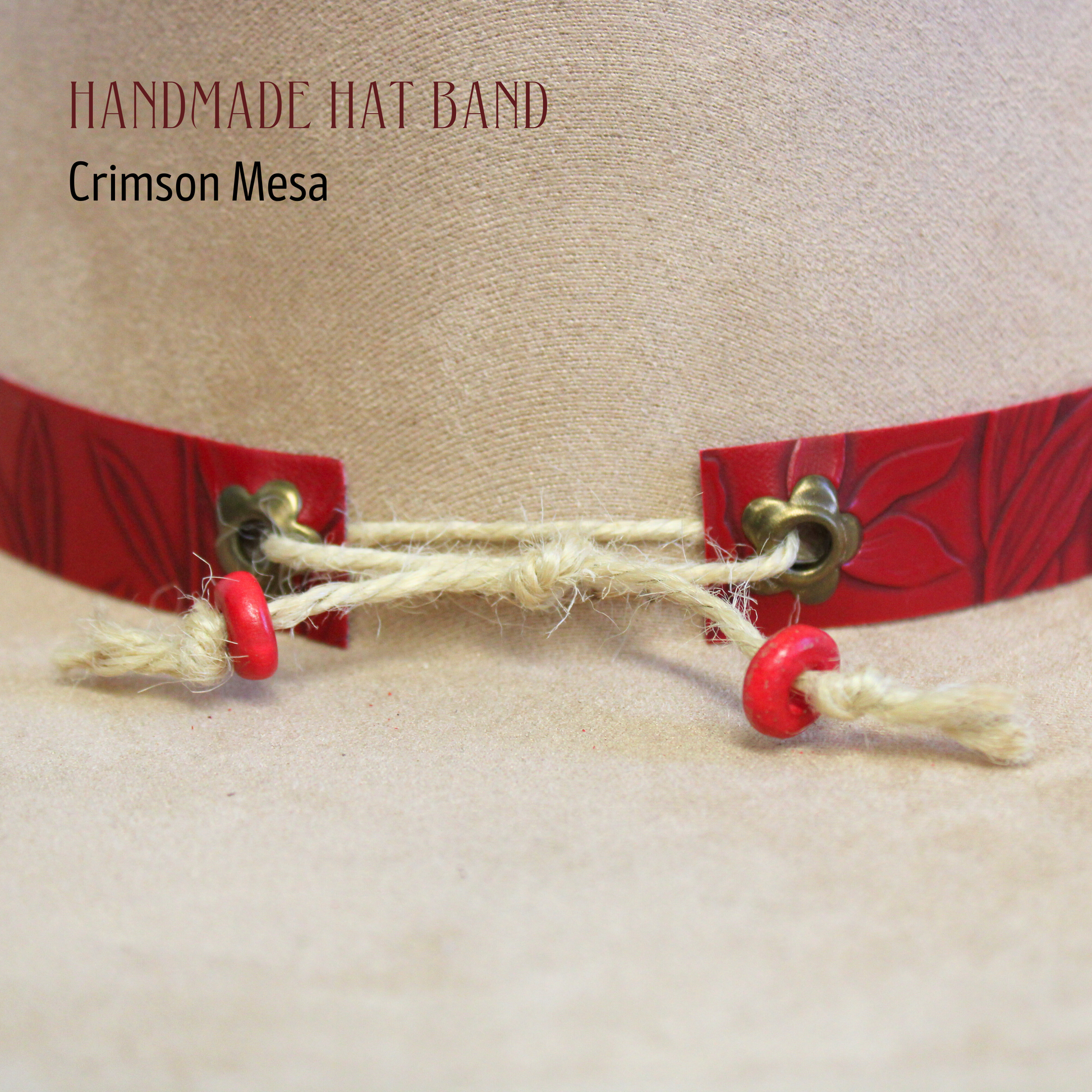 Handmade hat band with red accents and jingle bells on a beige background, featuring the brand 'Crimson Mesa'.