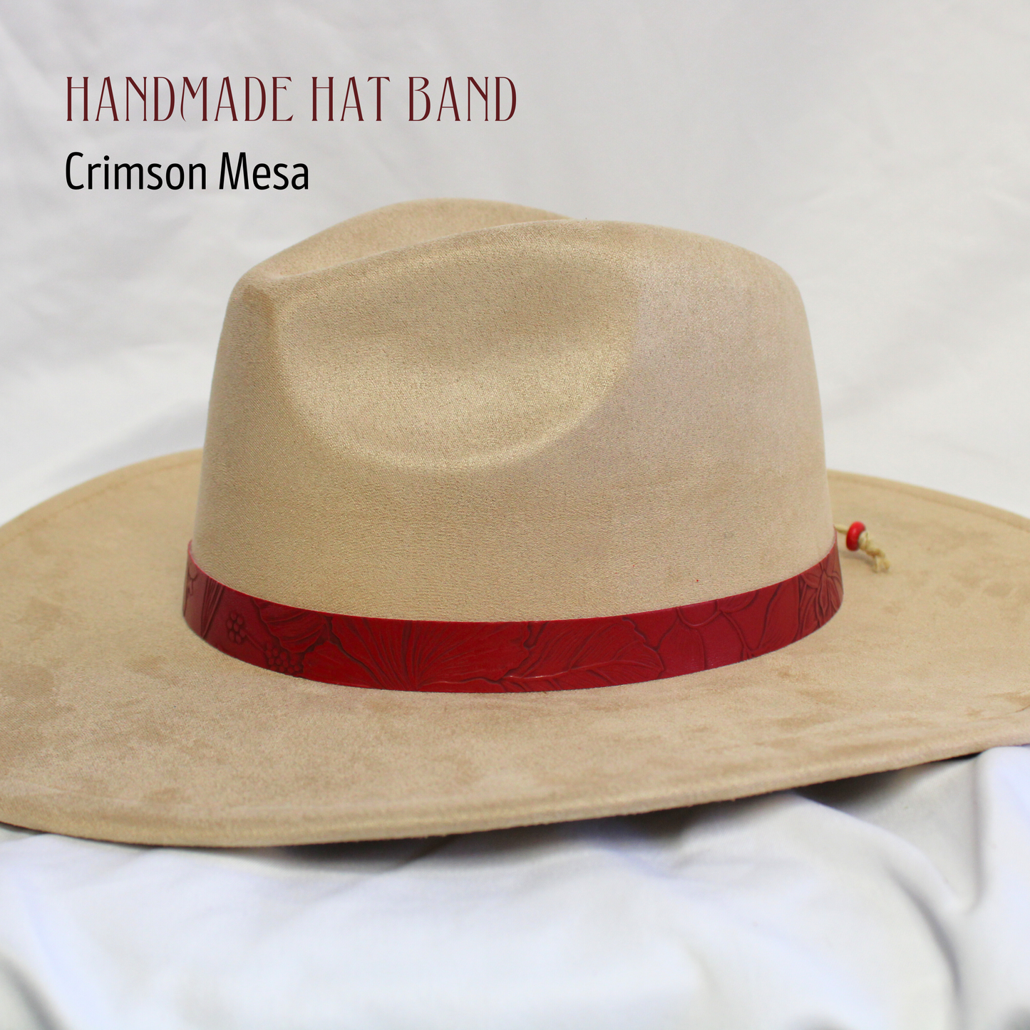 Beige cowboy hat with a red band on a white background, labeled 'Handmade Hat Band Crimson Mesa'.