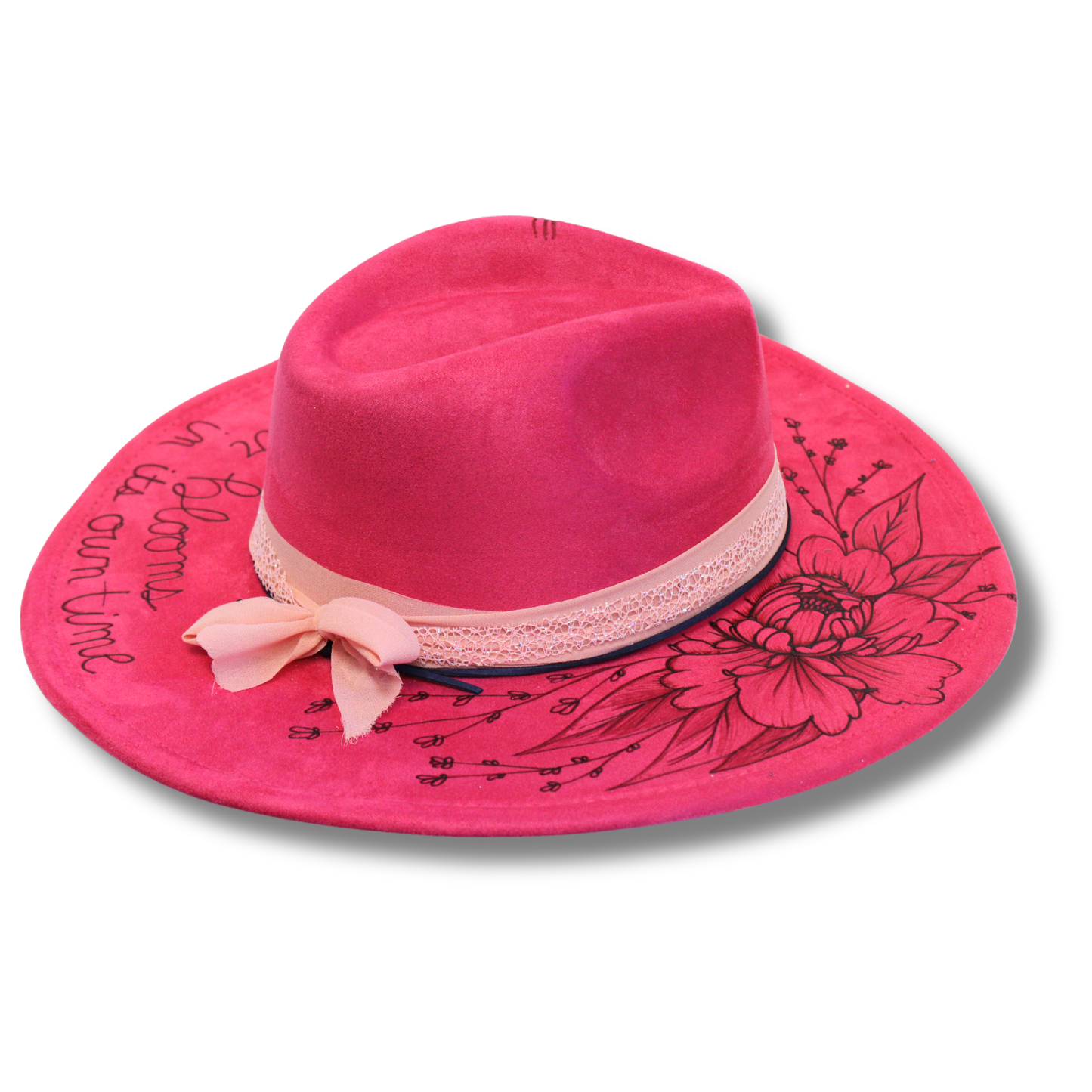 Pink hat with floral design and bow on a white background