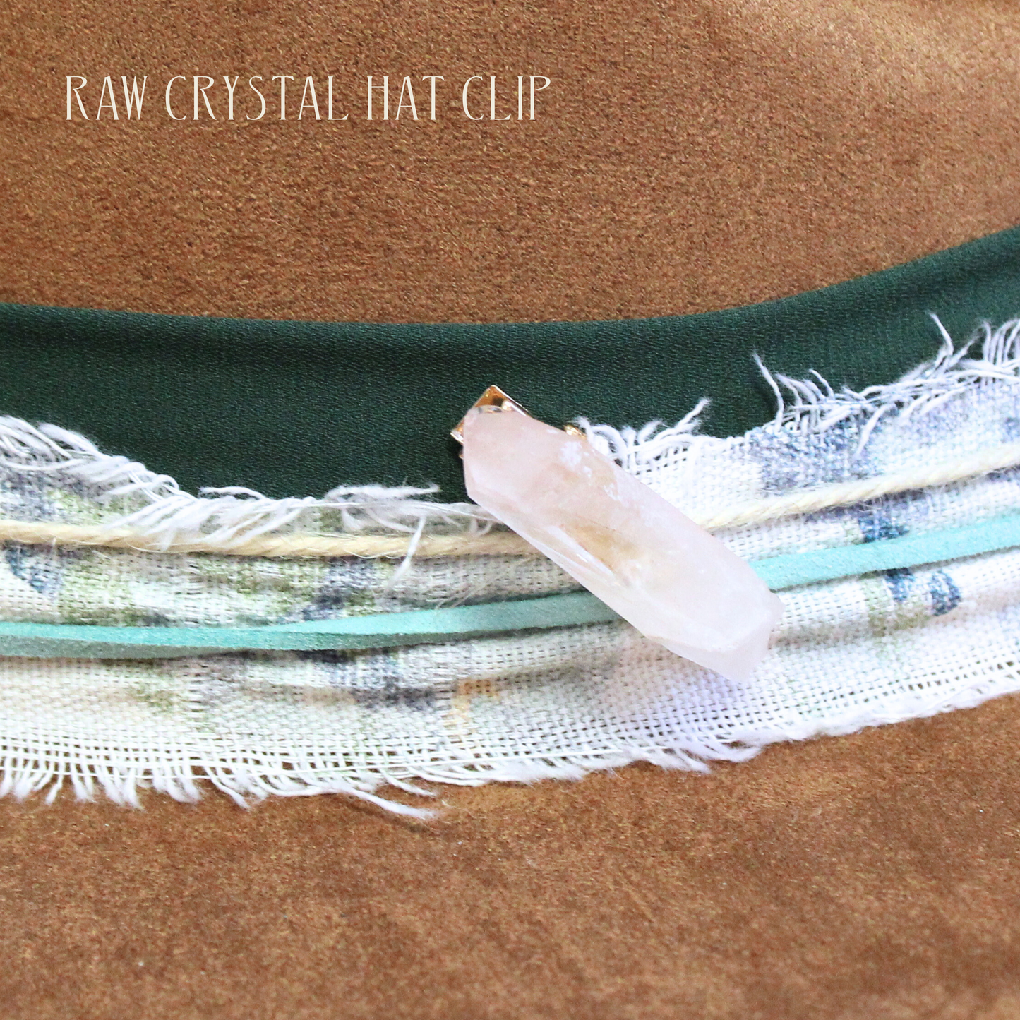 Brown hat with green band and raw crystal hat clip on a brown background