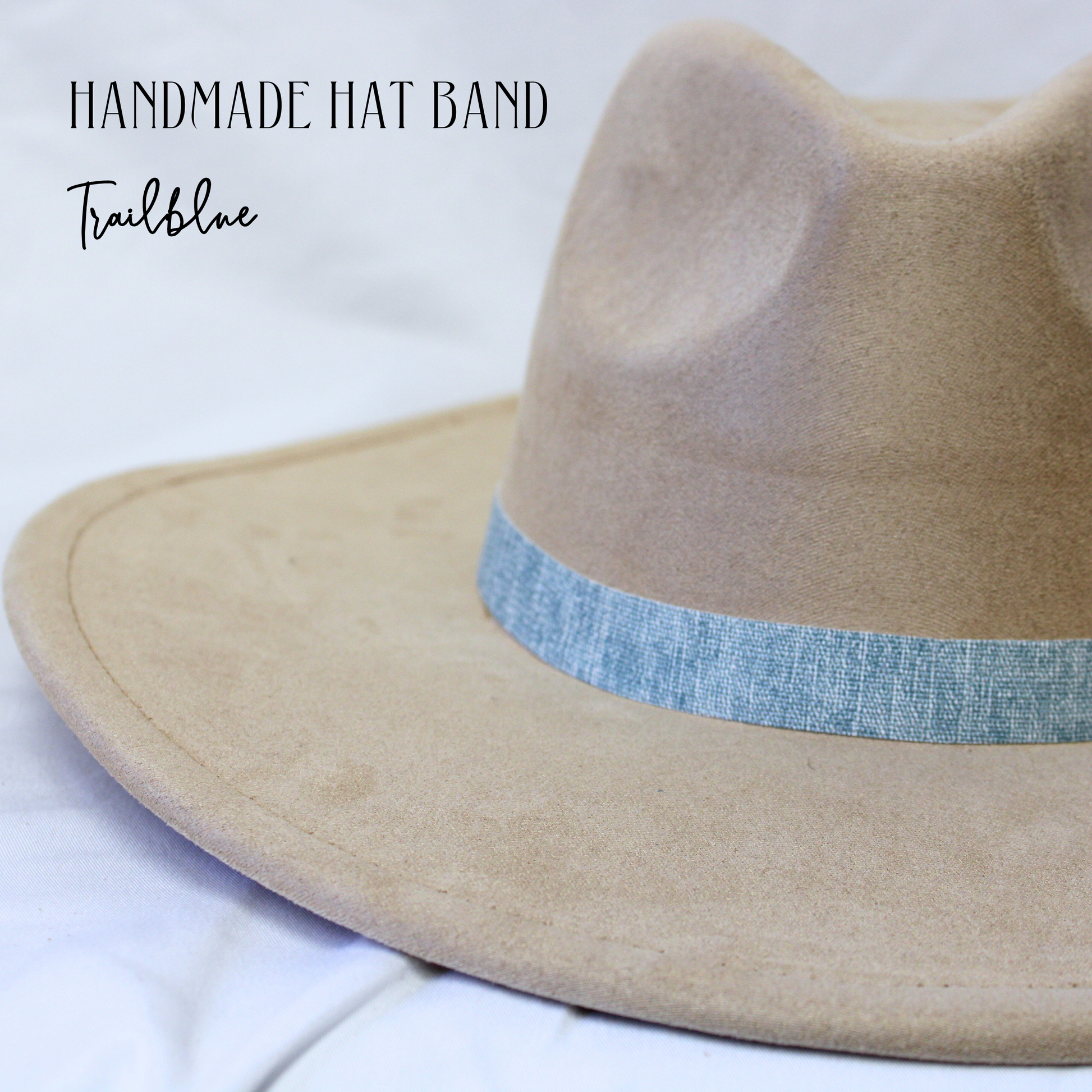 Beige hat with a blue band on a white background, labeled 'Handmade Hat Band Trailblue'.