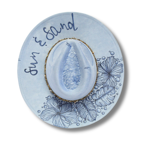 Decorative plate with shell design and 'Sun & Sand' text on a white background